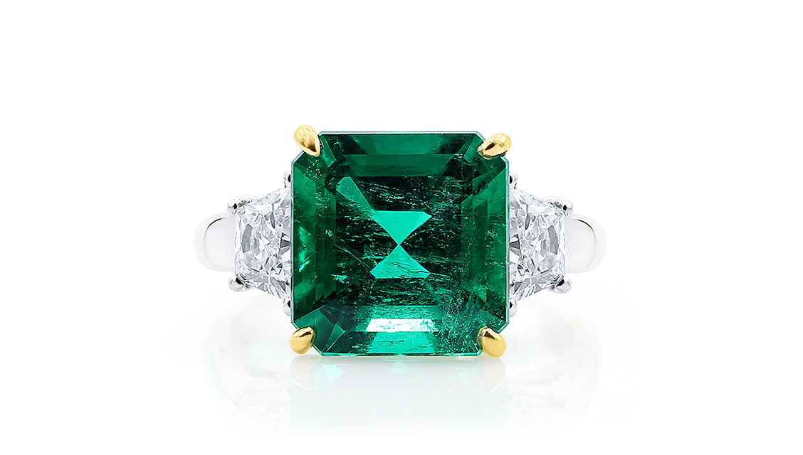 Platinum plated cz open ring with emerald green stone -